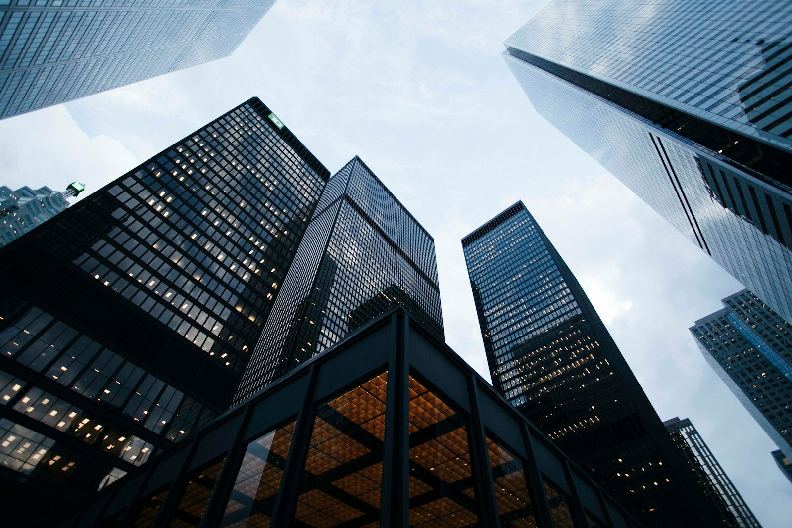 Oblique low-angle view of glass office tower facades, representing PropVeritas real estate intelligence